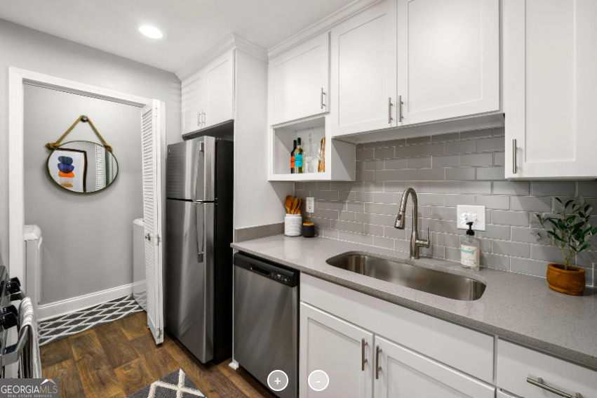 a kitchen with stainless steel appliances granite countertop a refrigerator and a sink