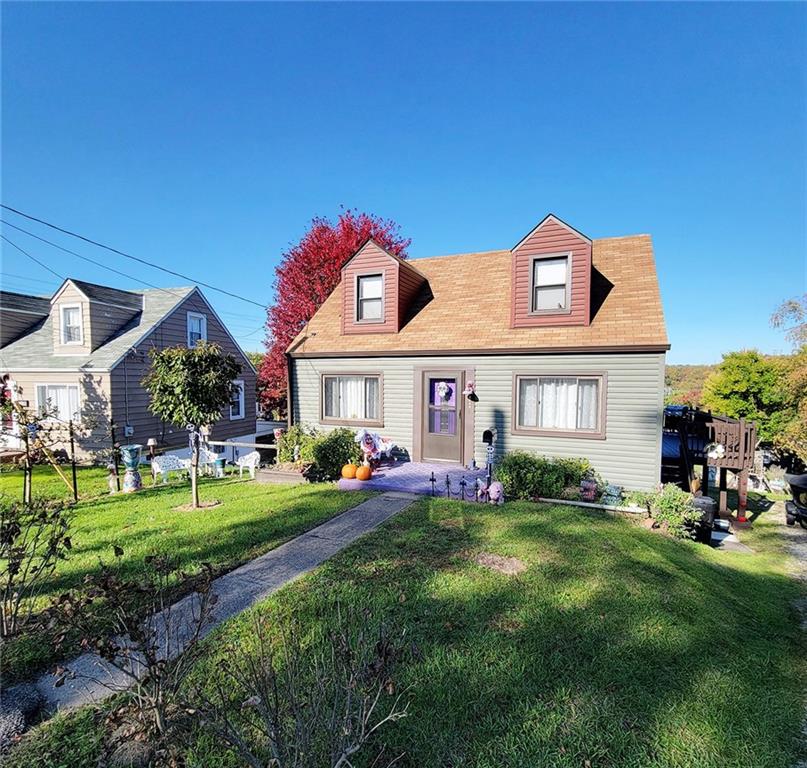 a front view of a house with a yard