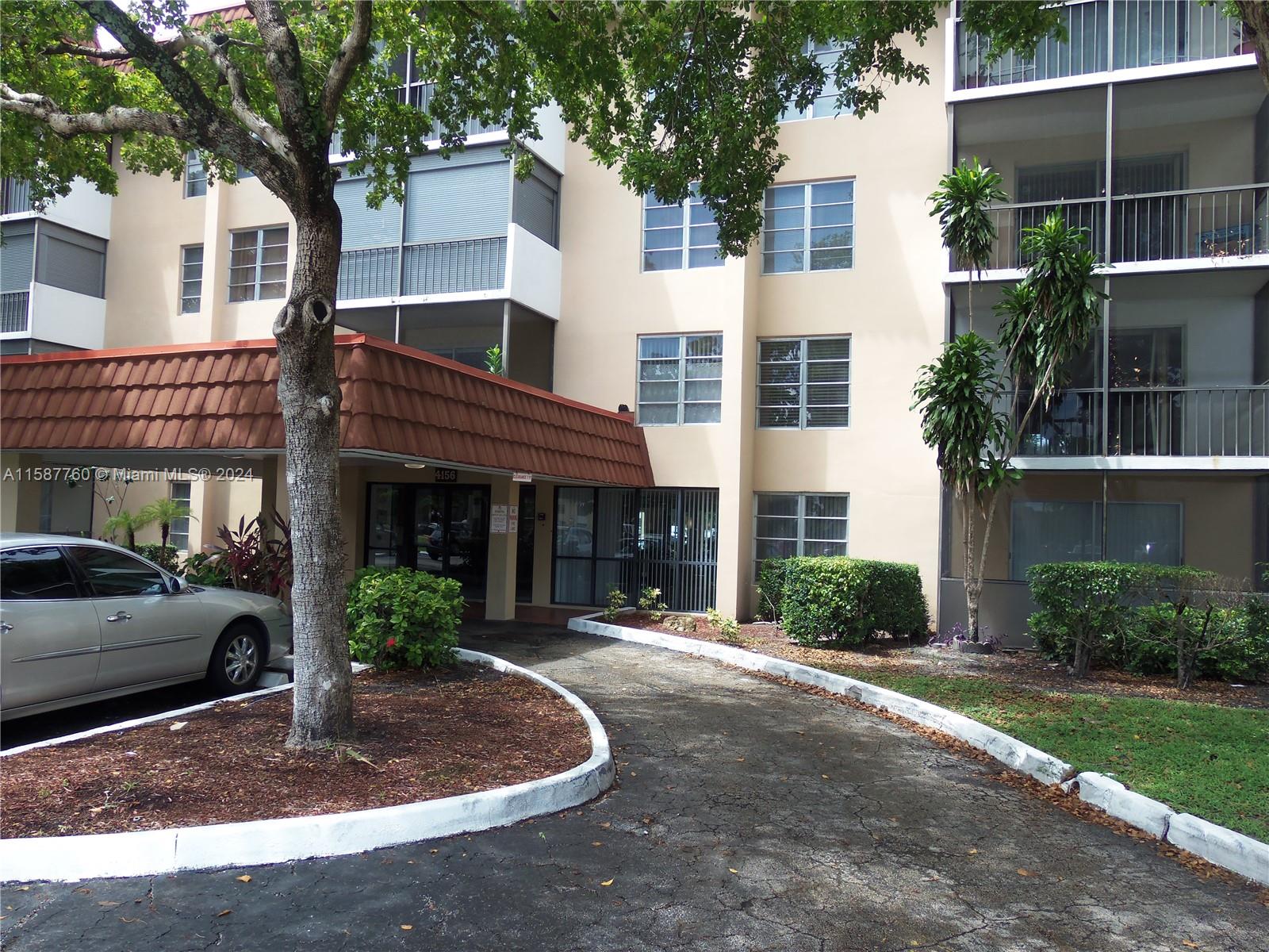 a view of a white building among the tree