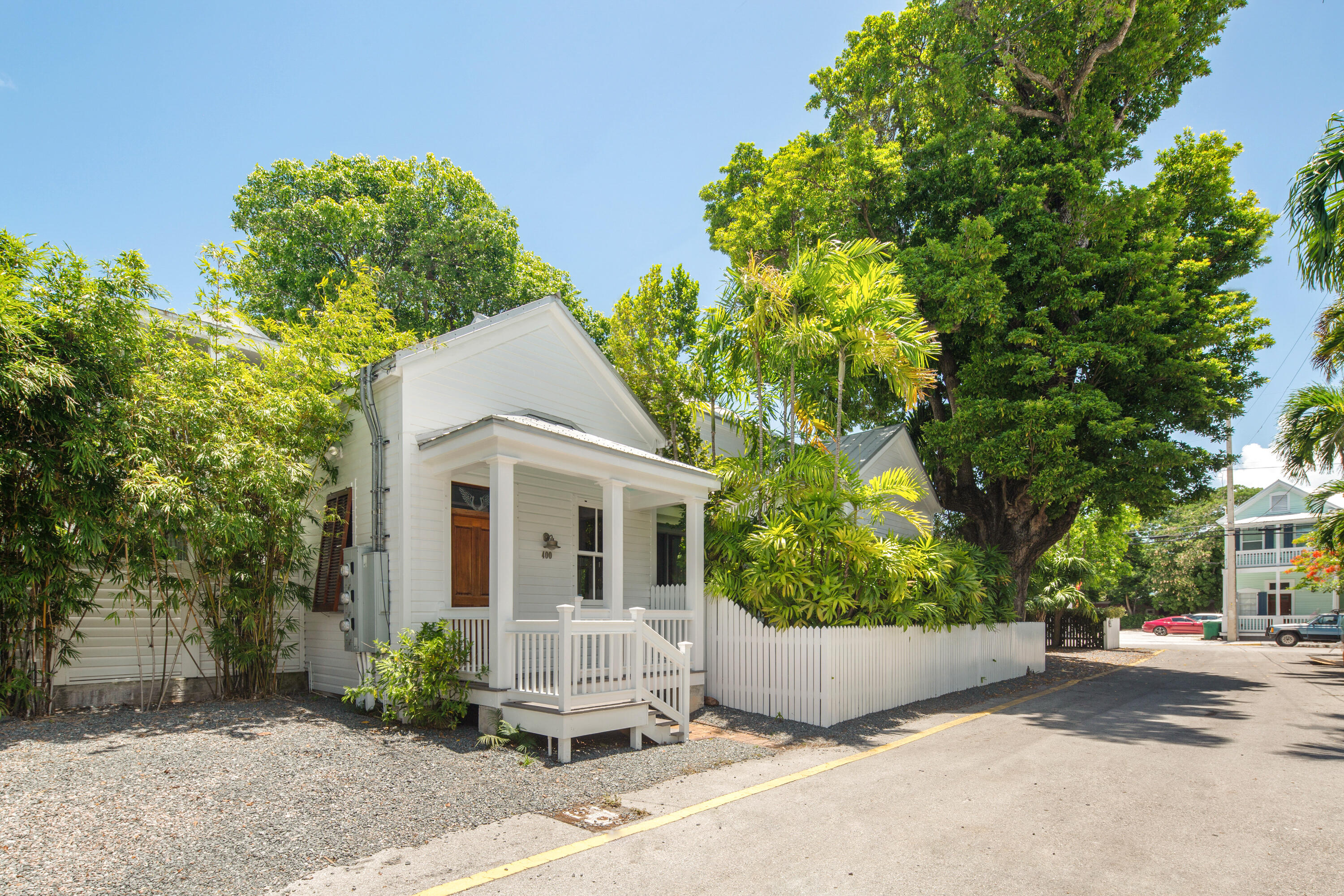 a front view of a house with a garden and plants