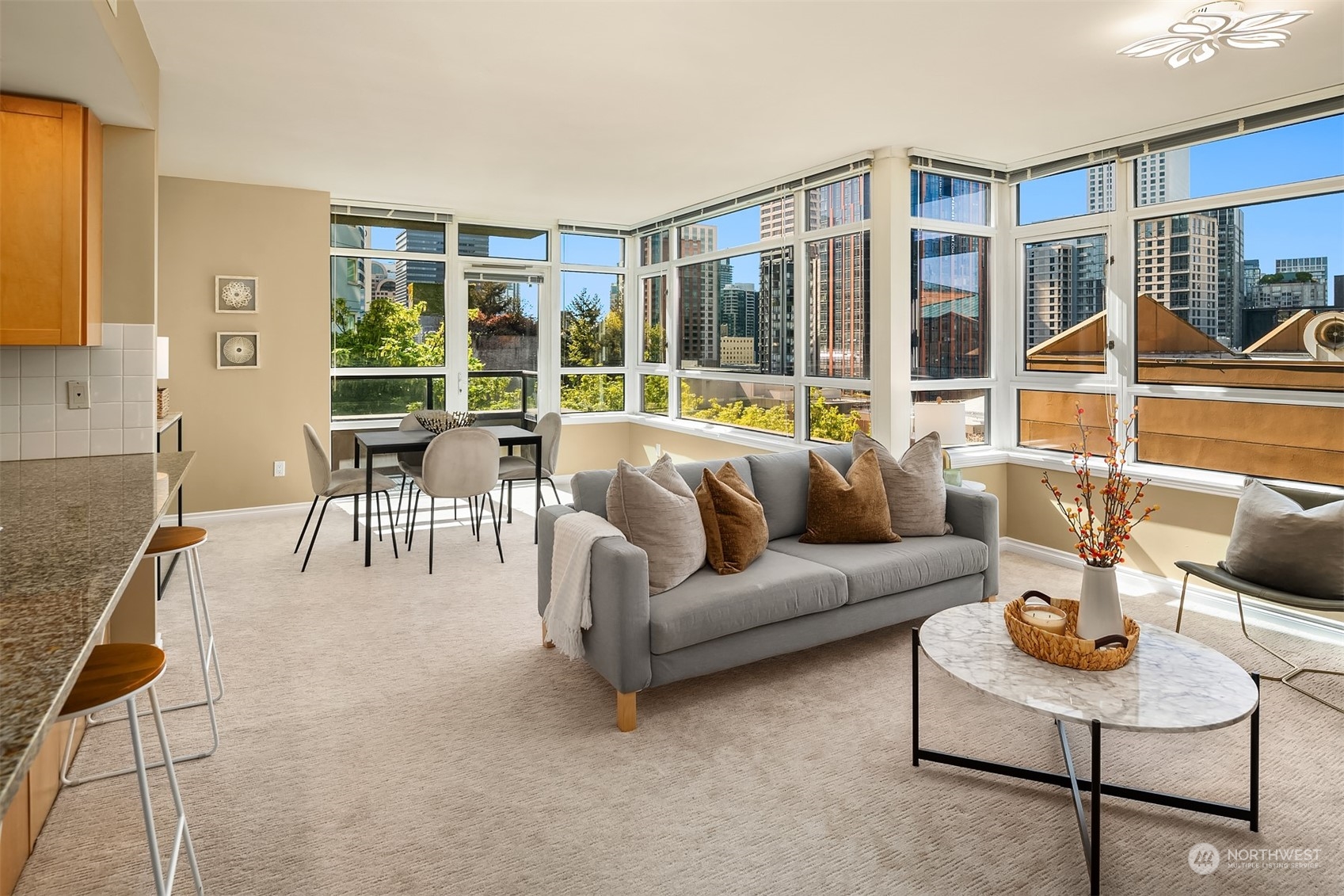 a living room with furniture and a floor to ceiling window