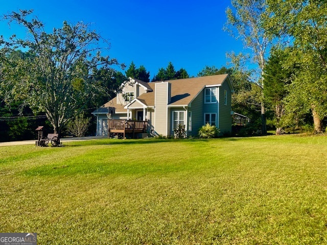 a front view of house with yard and green space