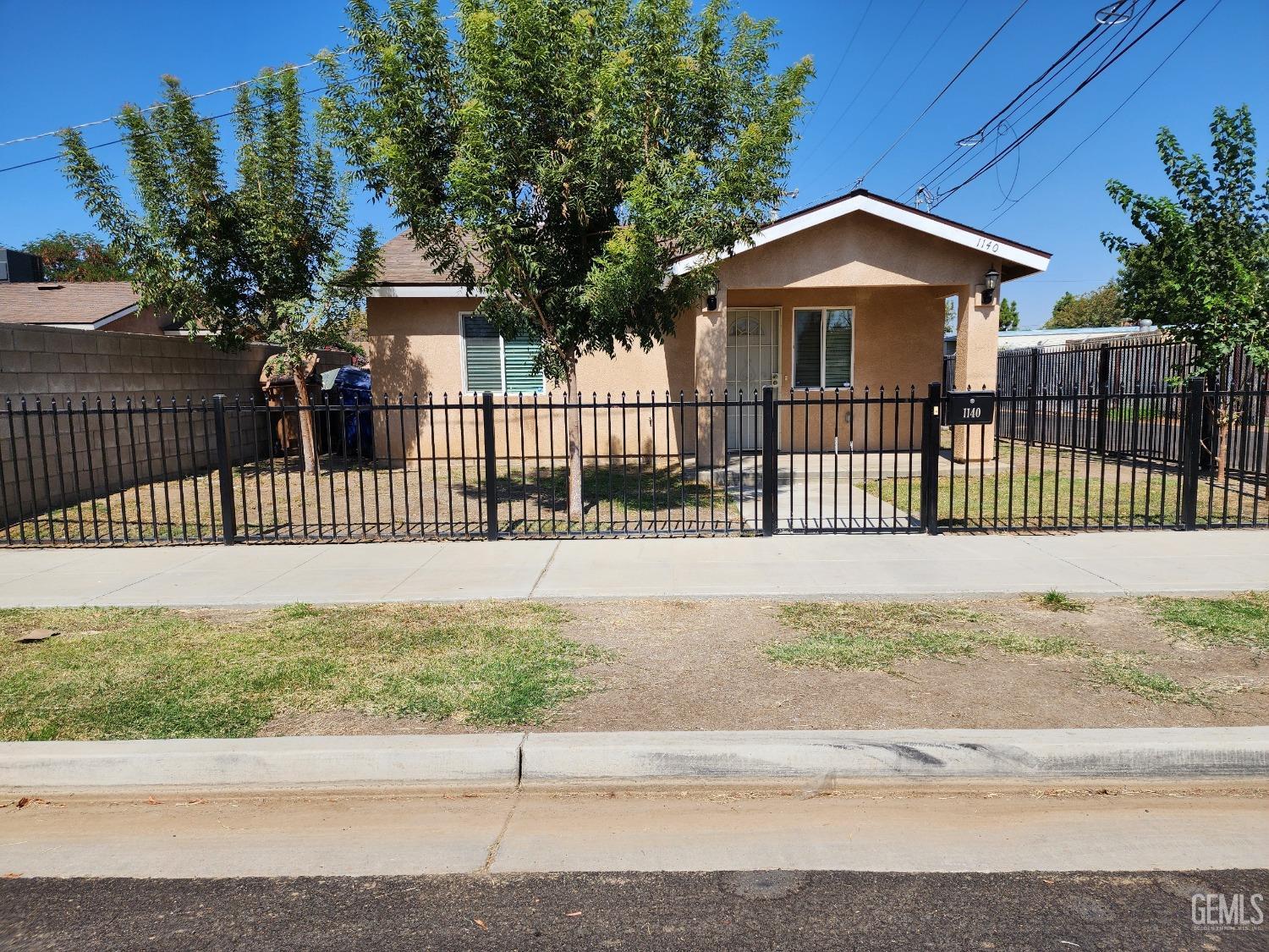 a view of a house with a fence