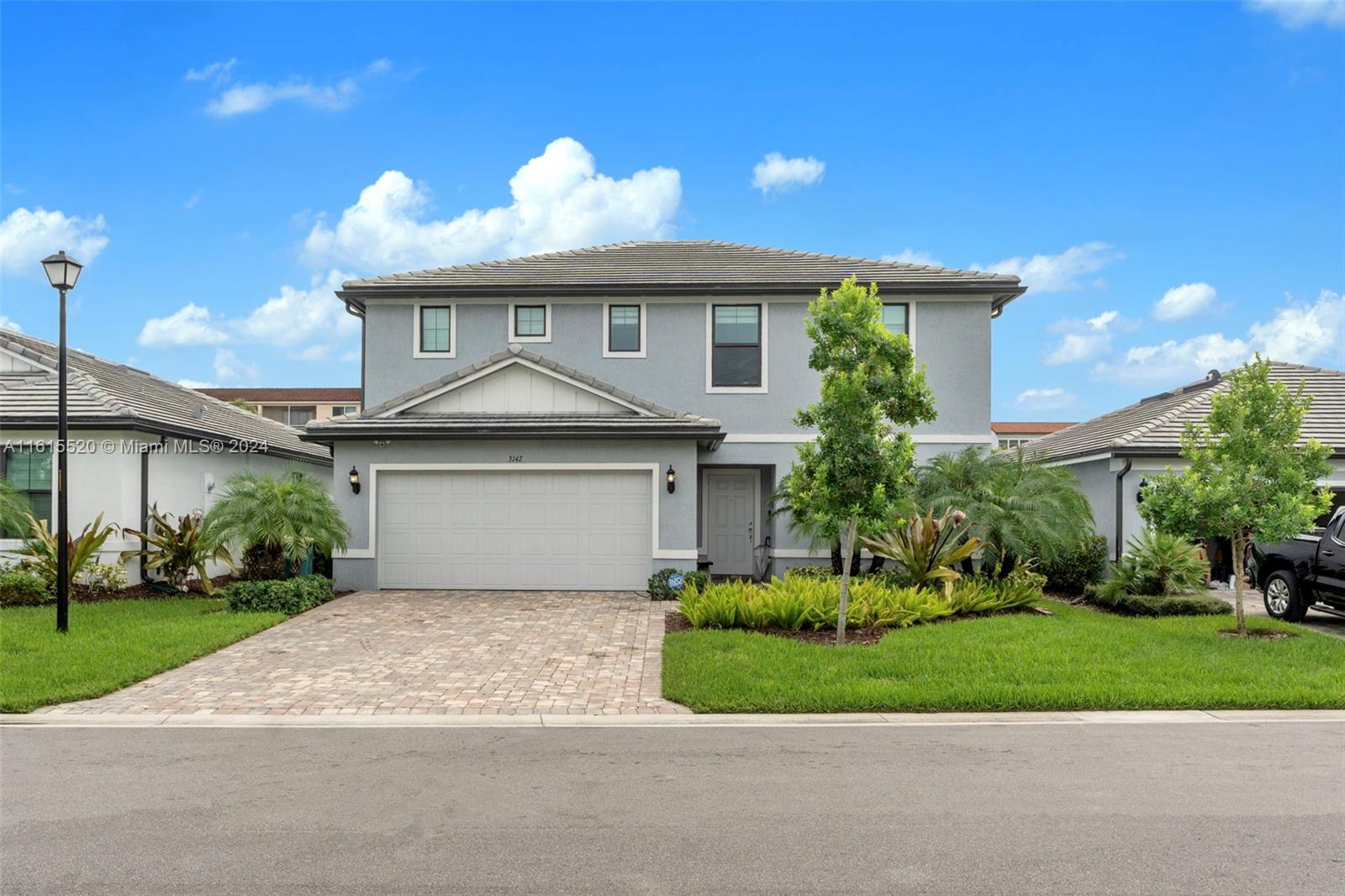 a front view of a house with a yard and garage