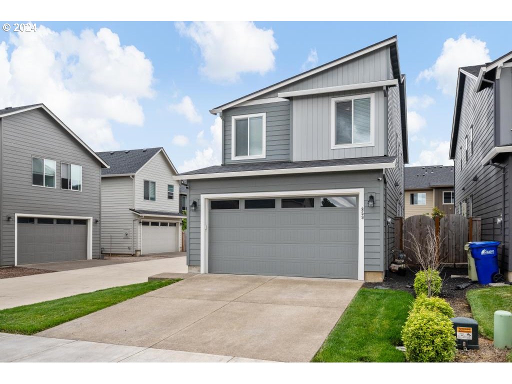 a front view of a house with a yard and garage