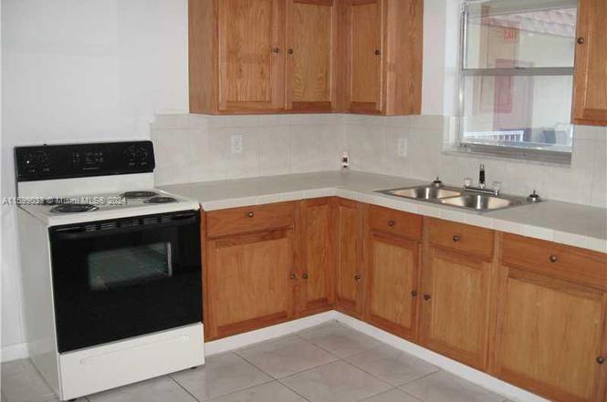 a kitchen with granite countertop cabinets stainless steel appliances and sink