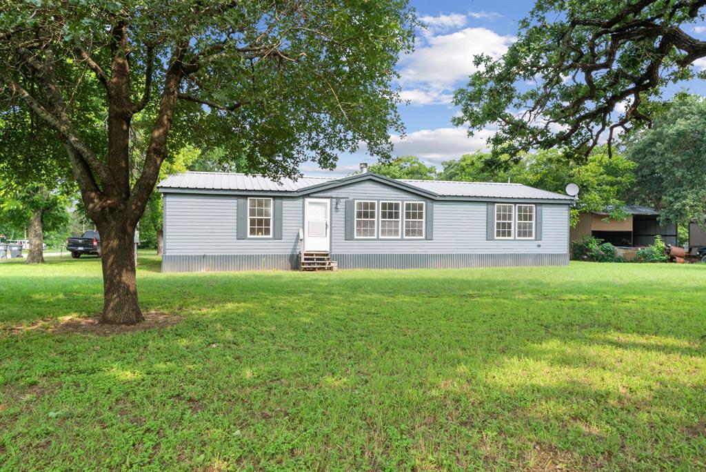 a view of a house with a backyard