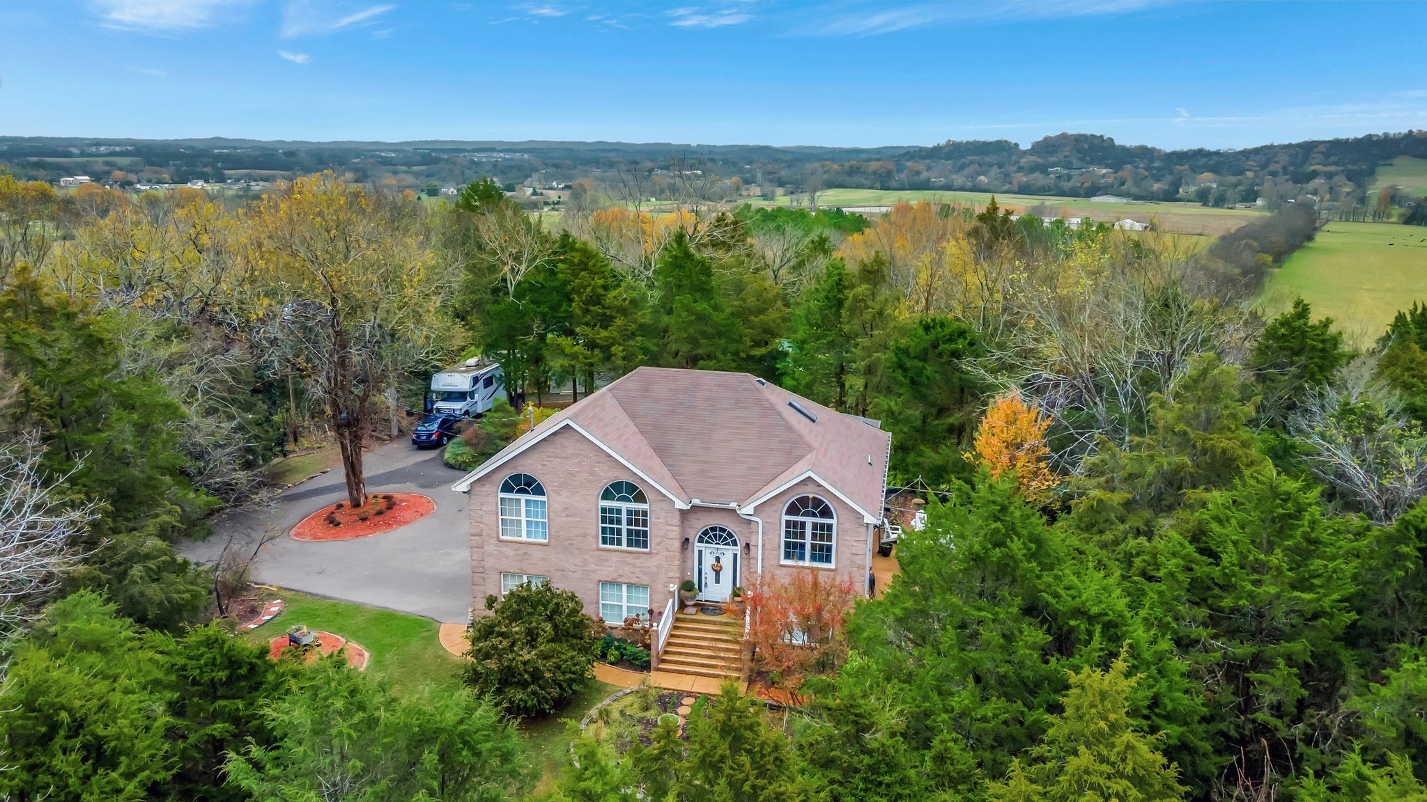 an aerial view of a house with outdoor space and lake view