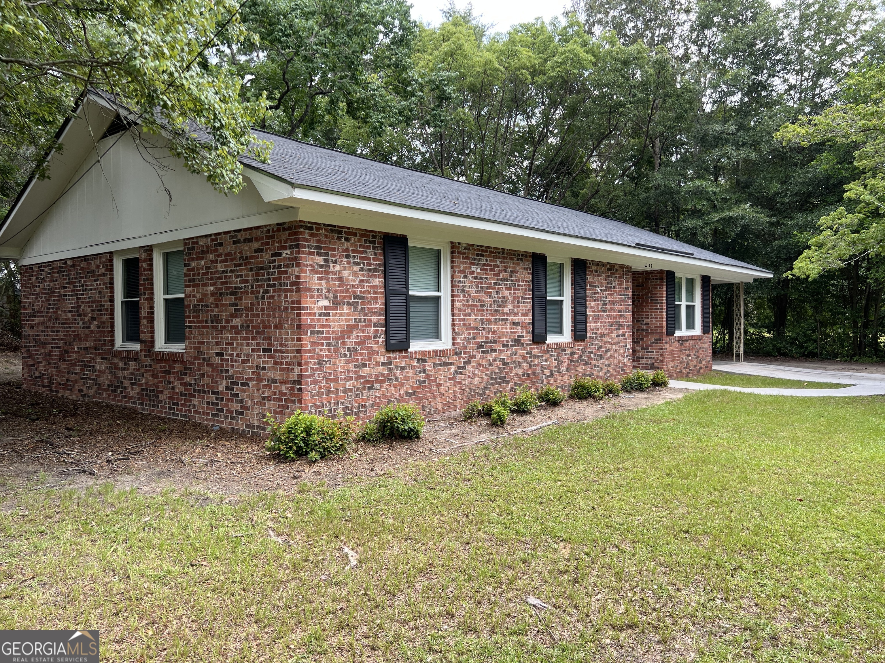 a front view of a house with garden