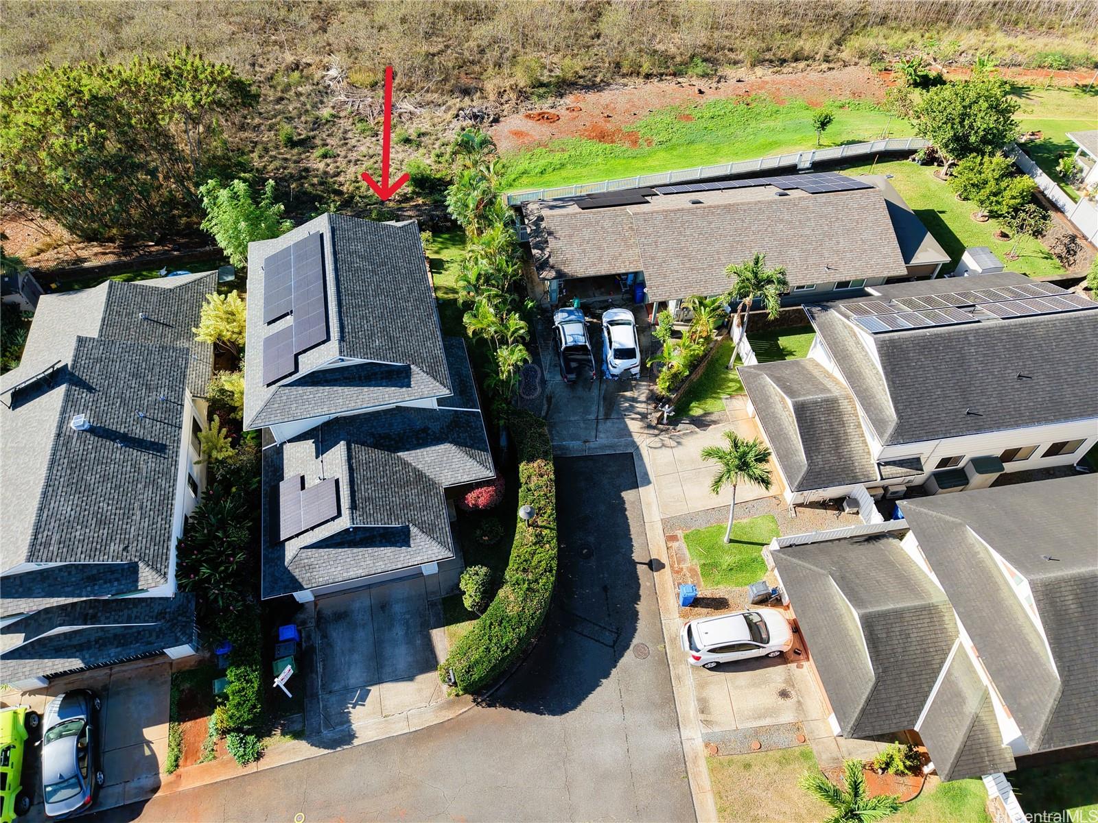 an aerial view of a house with garden space and street view