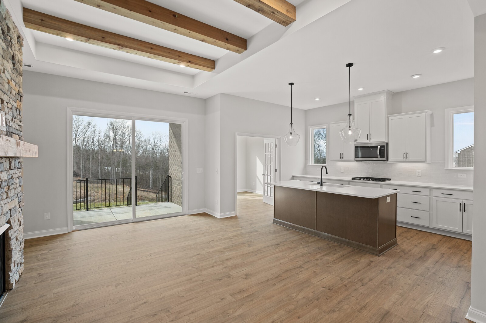 a large kitchen with kitchen island a large counter top space a sink stainless steel appliances and cabinets