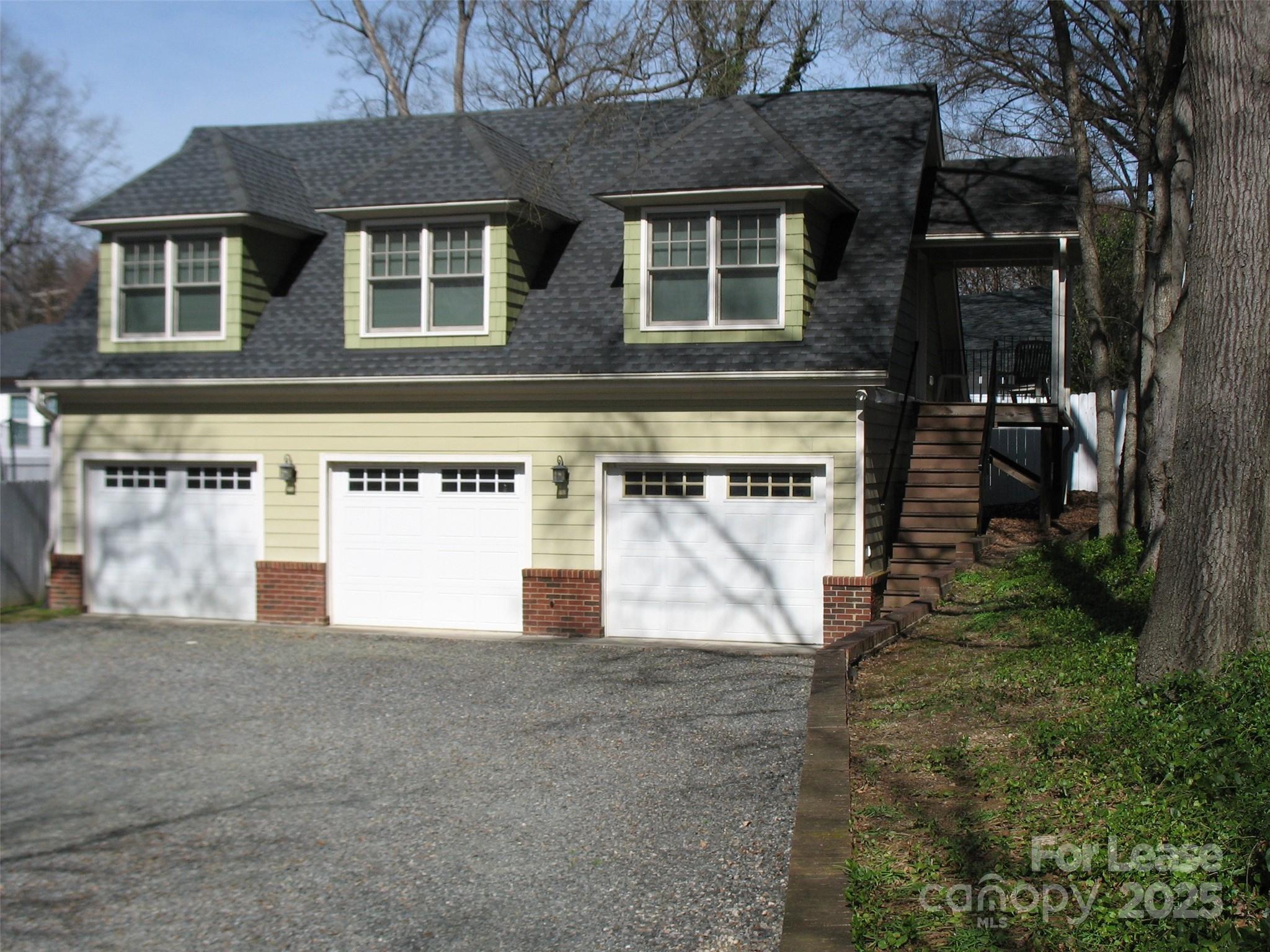 a view of a house with a yard and garage