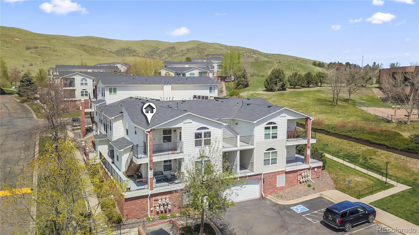 an aerial view of residential houses with outdoor space and river