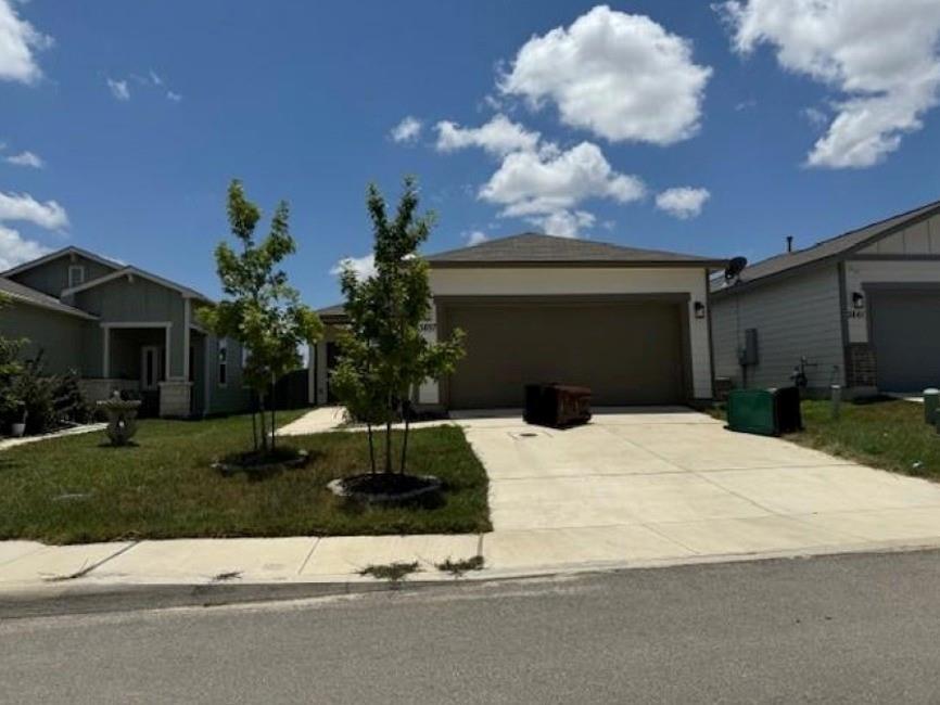 a front view of a house with garden and parking