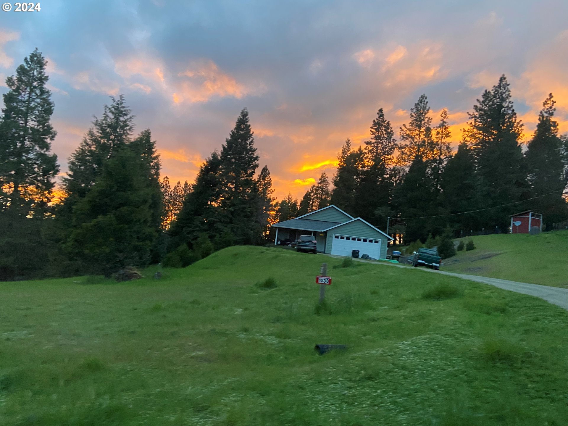 a view of a big yard with a house in the background