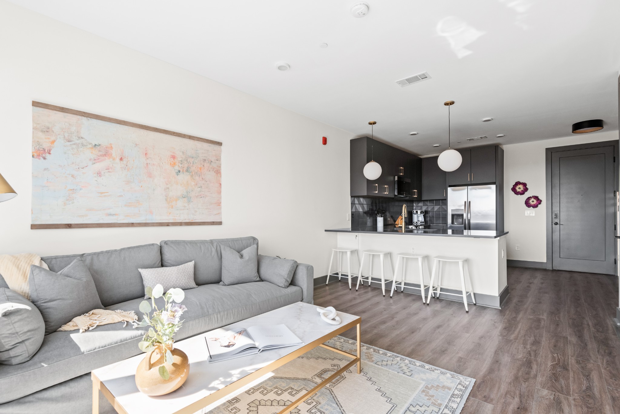 a living room with furniture and wooden floor