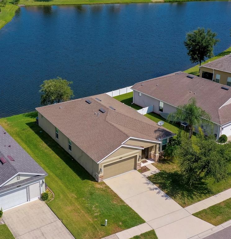 an aerial view of a house with a yard