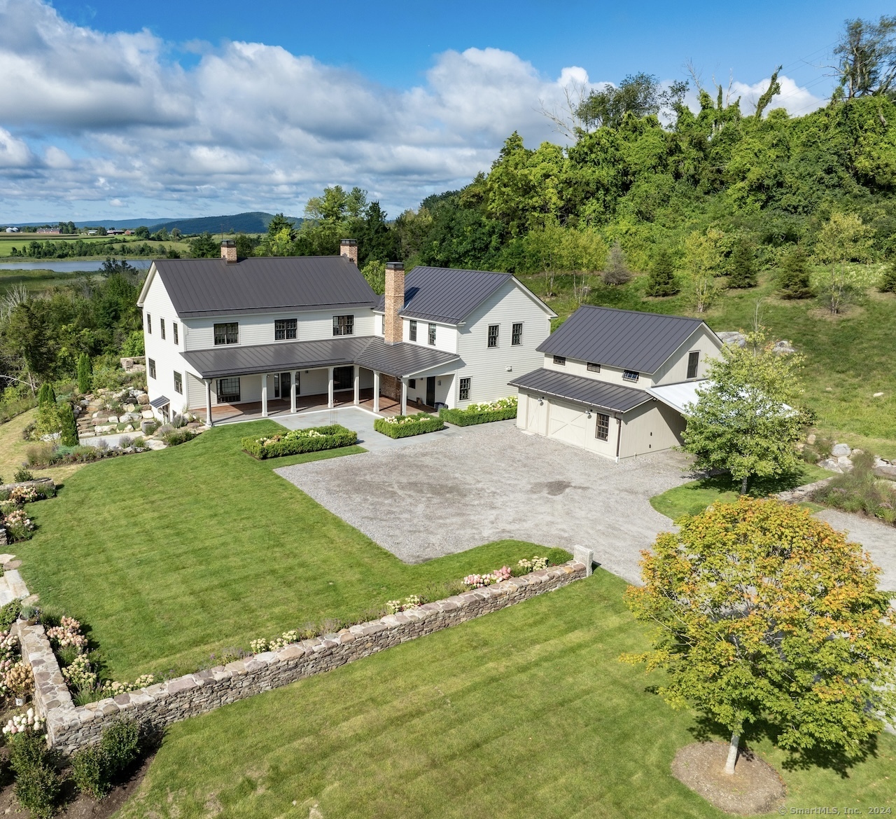 an aerial view of residential houses with outdoor space and trees