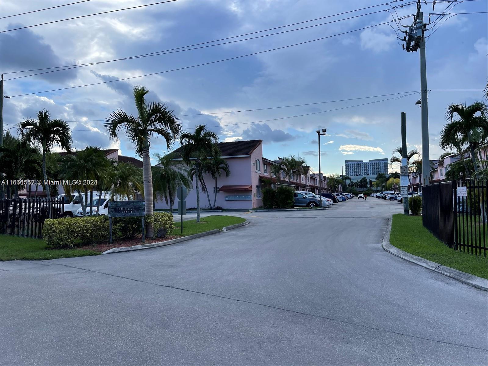 a view of a street with cars parked