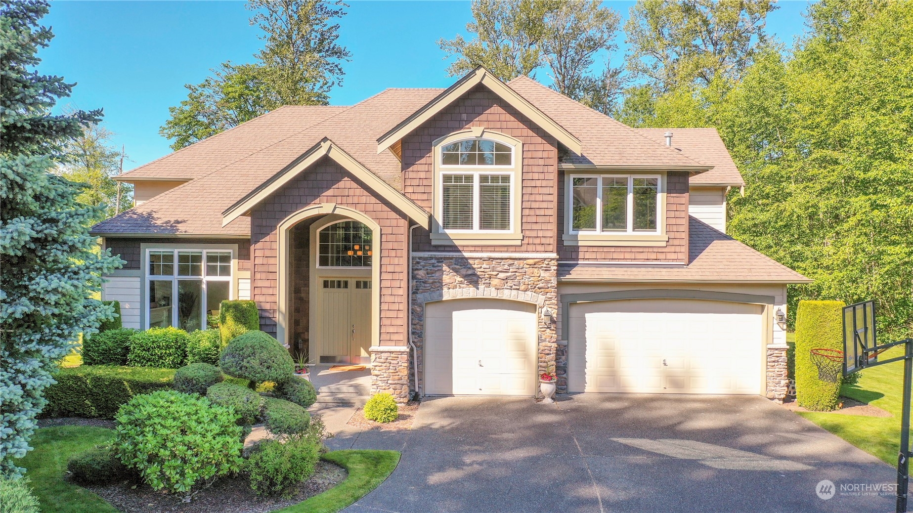 a front view of a house with a yard and garage