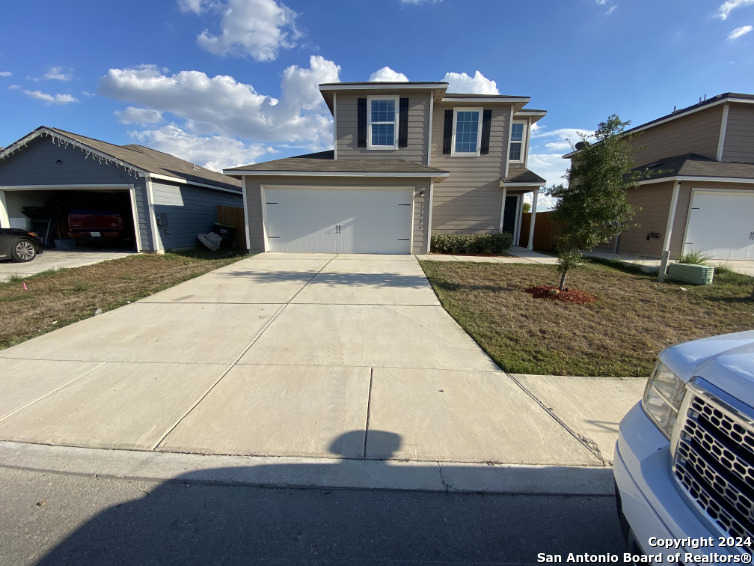 a front view of a house with yard