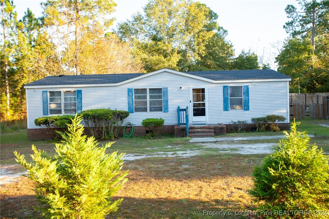 a view of a house with a yard patio and a garden