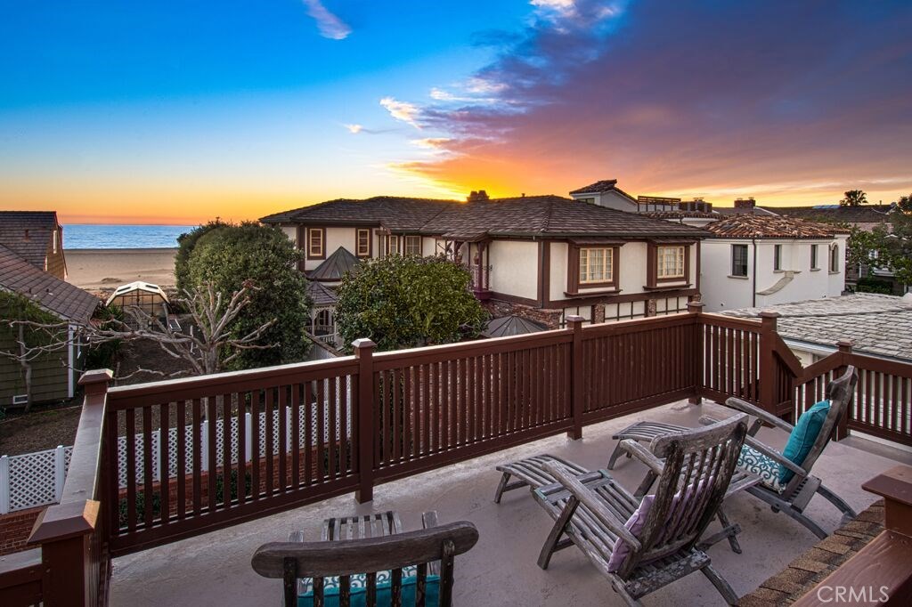 a view of a roof deck with table and chairs