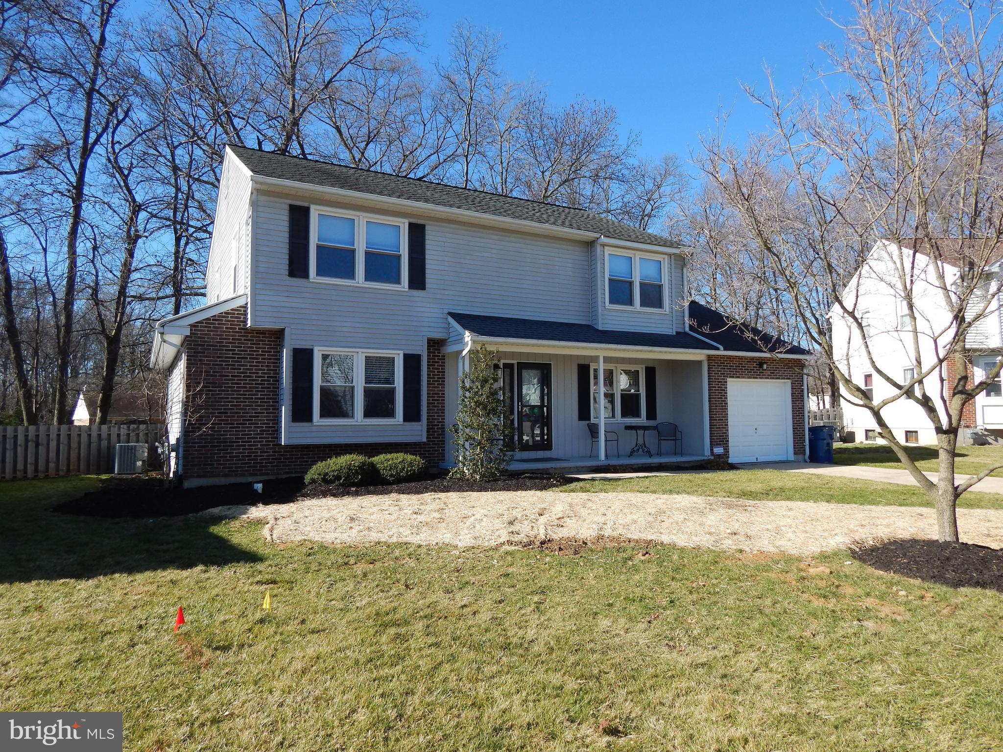 a front view of a house with a yard covered with snow