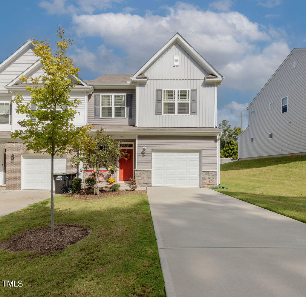 a front view of a house with a yard and garage