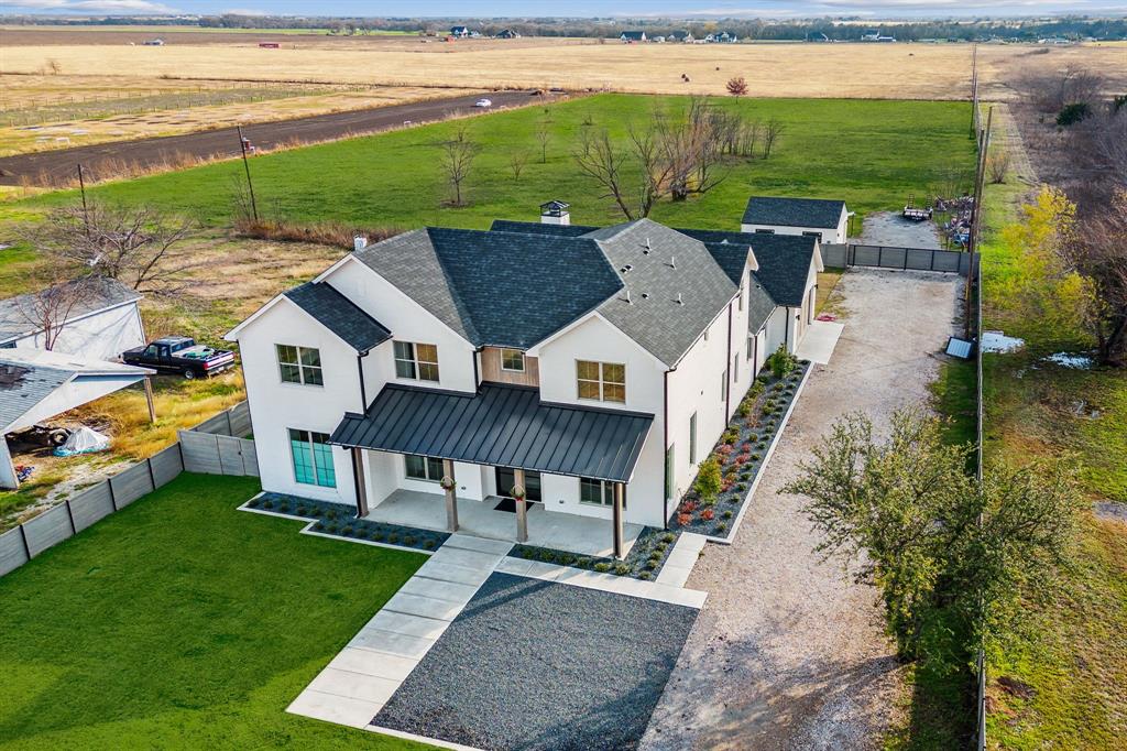 an aerial view of a house with swimming pool garden and patio