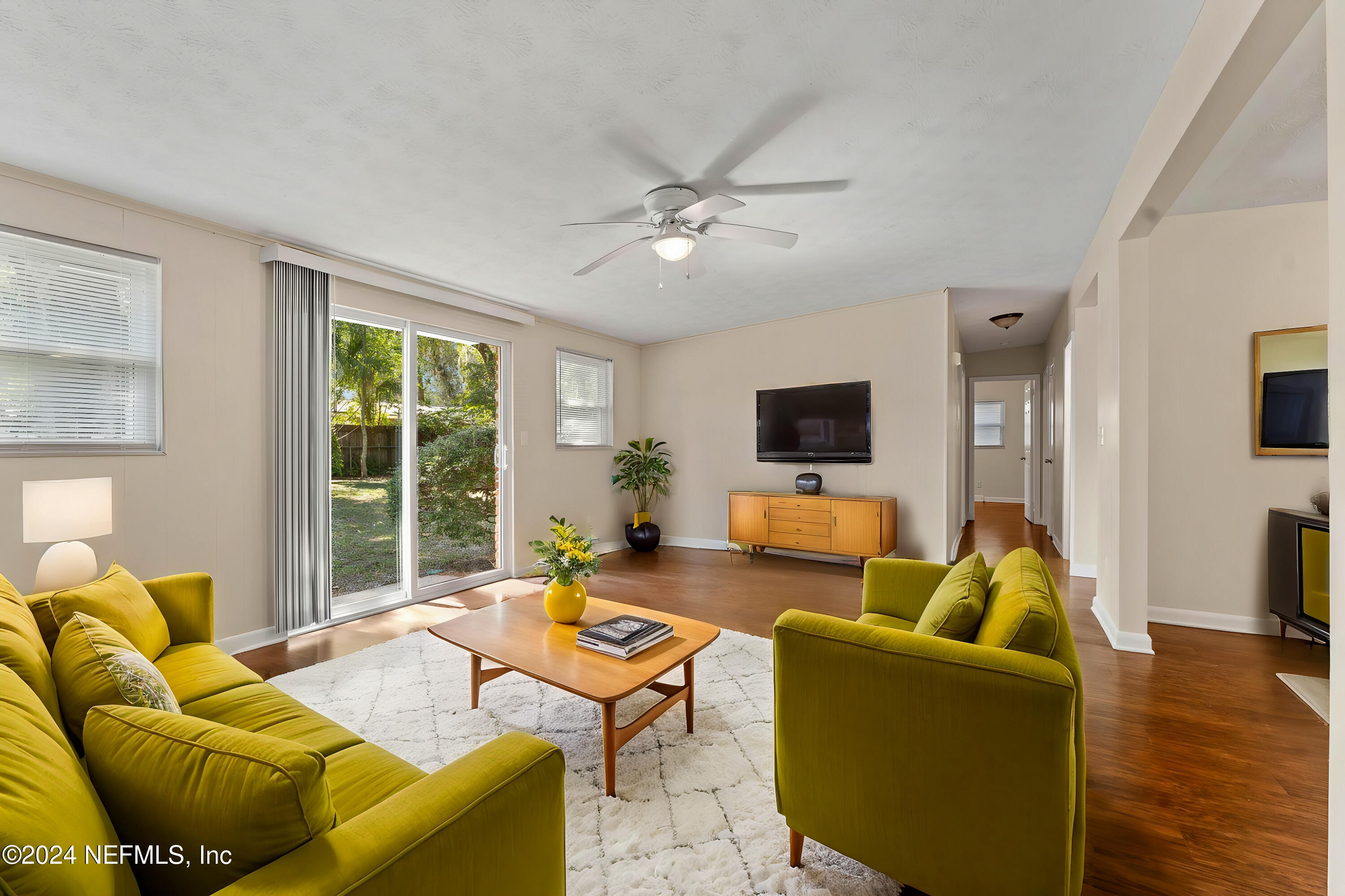 a living room with furniture and a flat screen tv