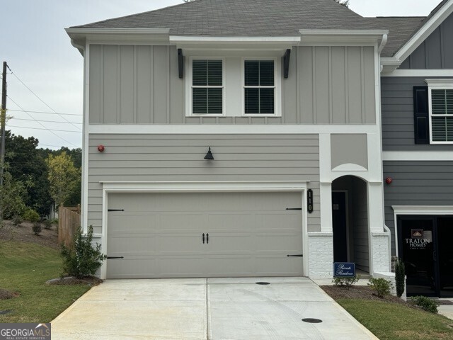 a front view of a house with garage