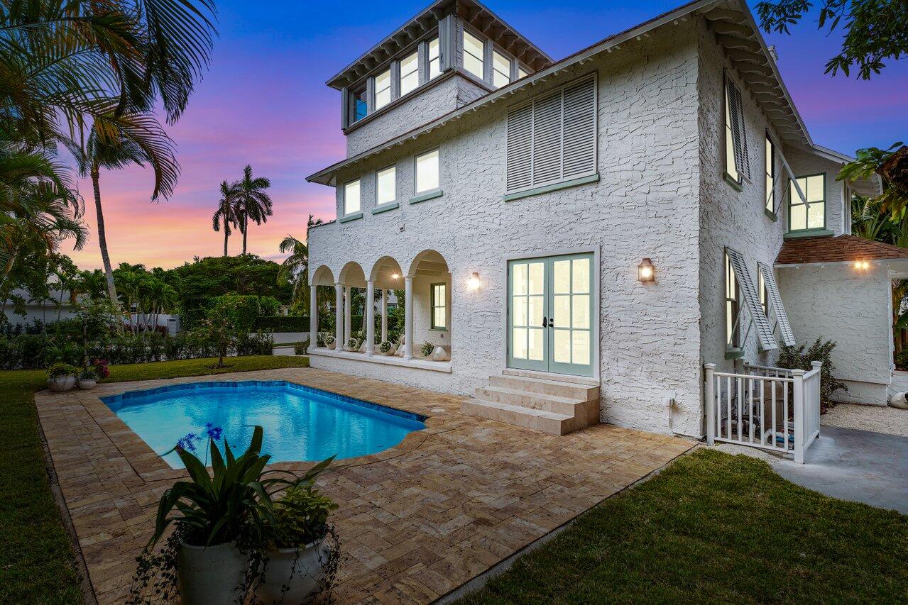 a view of a house with pool and sitting area