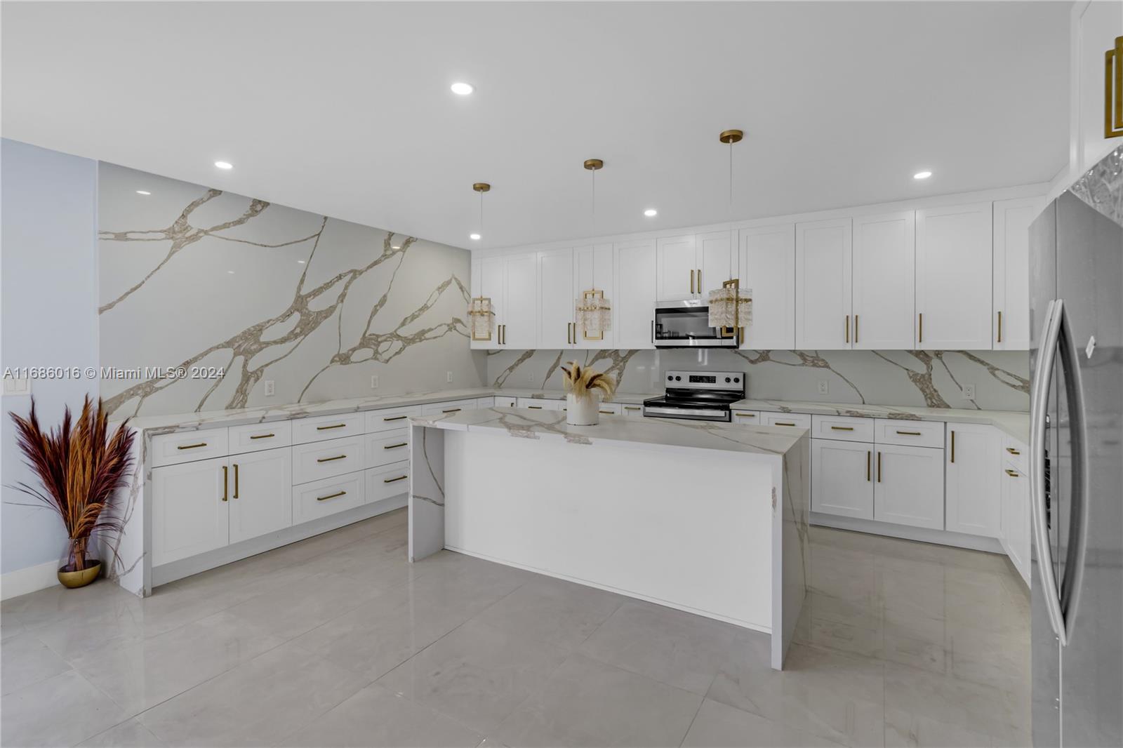 a kitchen with granite countertop white cabinets and stainless steel appliances