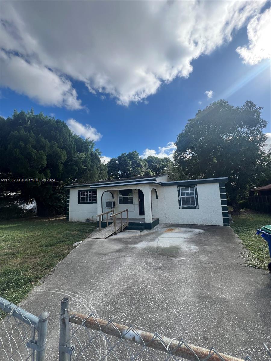 a view of a house with a yard and garage