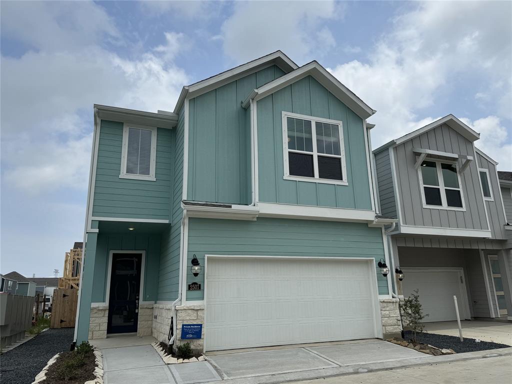 a front view of a house with garage