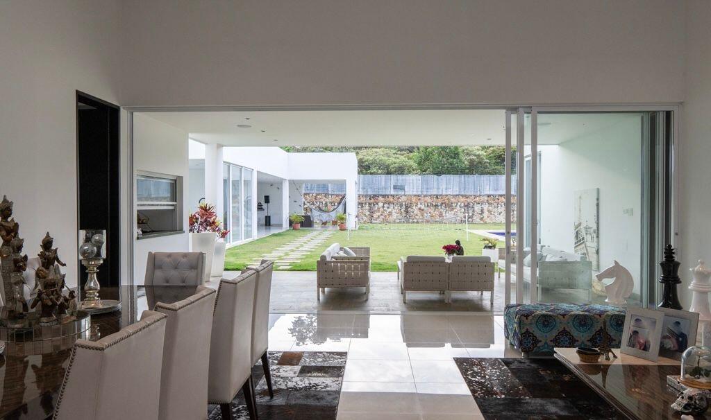 a living room with furniture and a floor to ceiling window