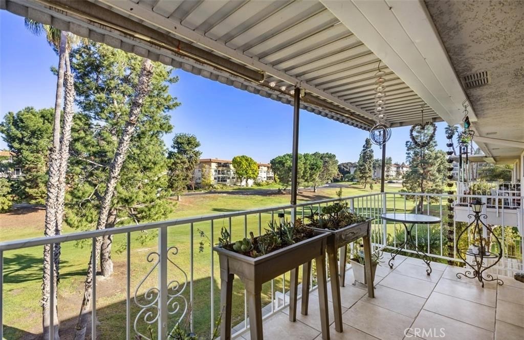 a city view from a balcony with chairs