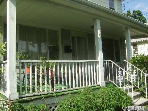 View of property exterior featuring covered porch