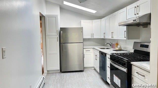 a kitchen with a refrigerator a stove a sink and cabinets