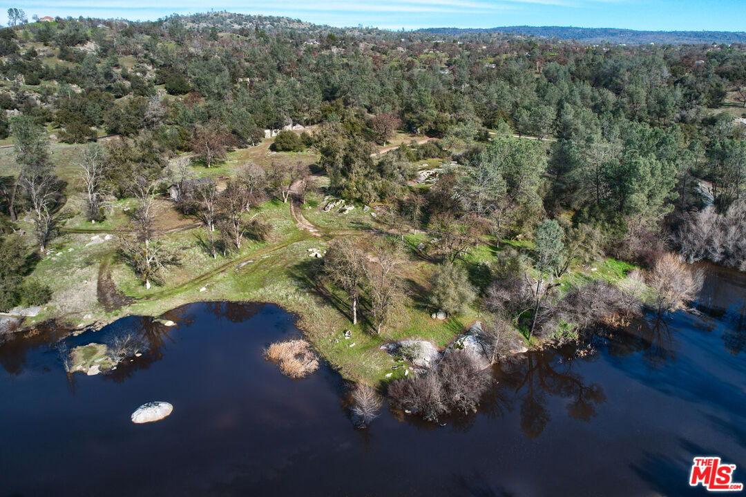 an aerial view of a house with yard