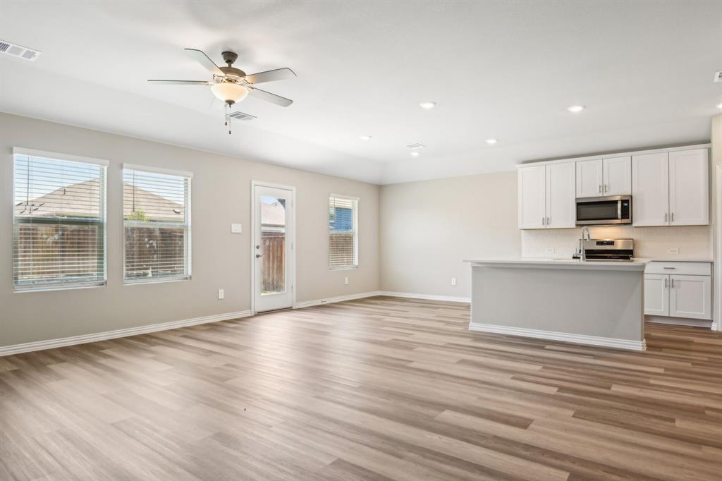 a view of kitchen with granite countertop cabinets and wooden floor