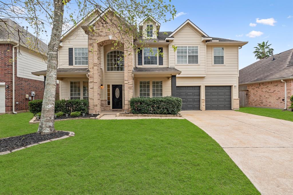 Beautiful curb appeal with trees trimmed, fresh mulch, and fresh paint.