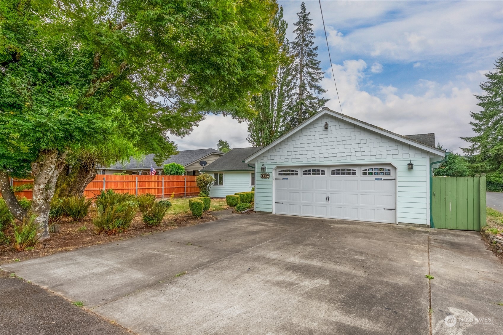 a view of a house with a yard and garage