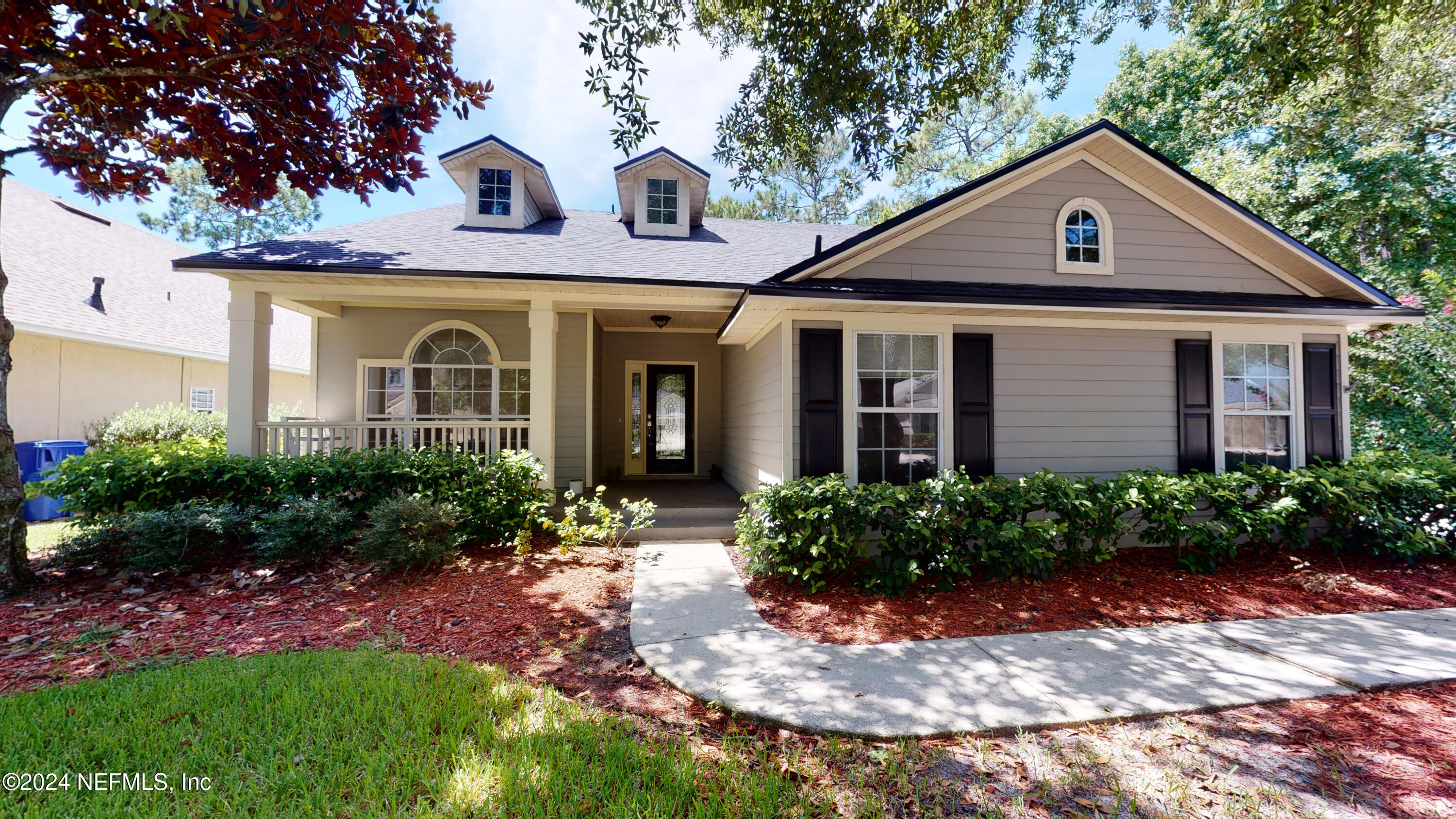 a front view of a house with garden