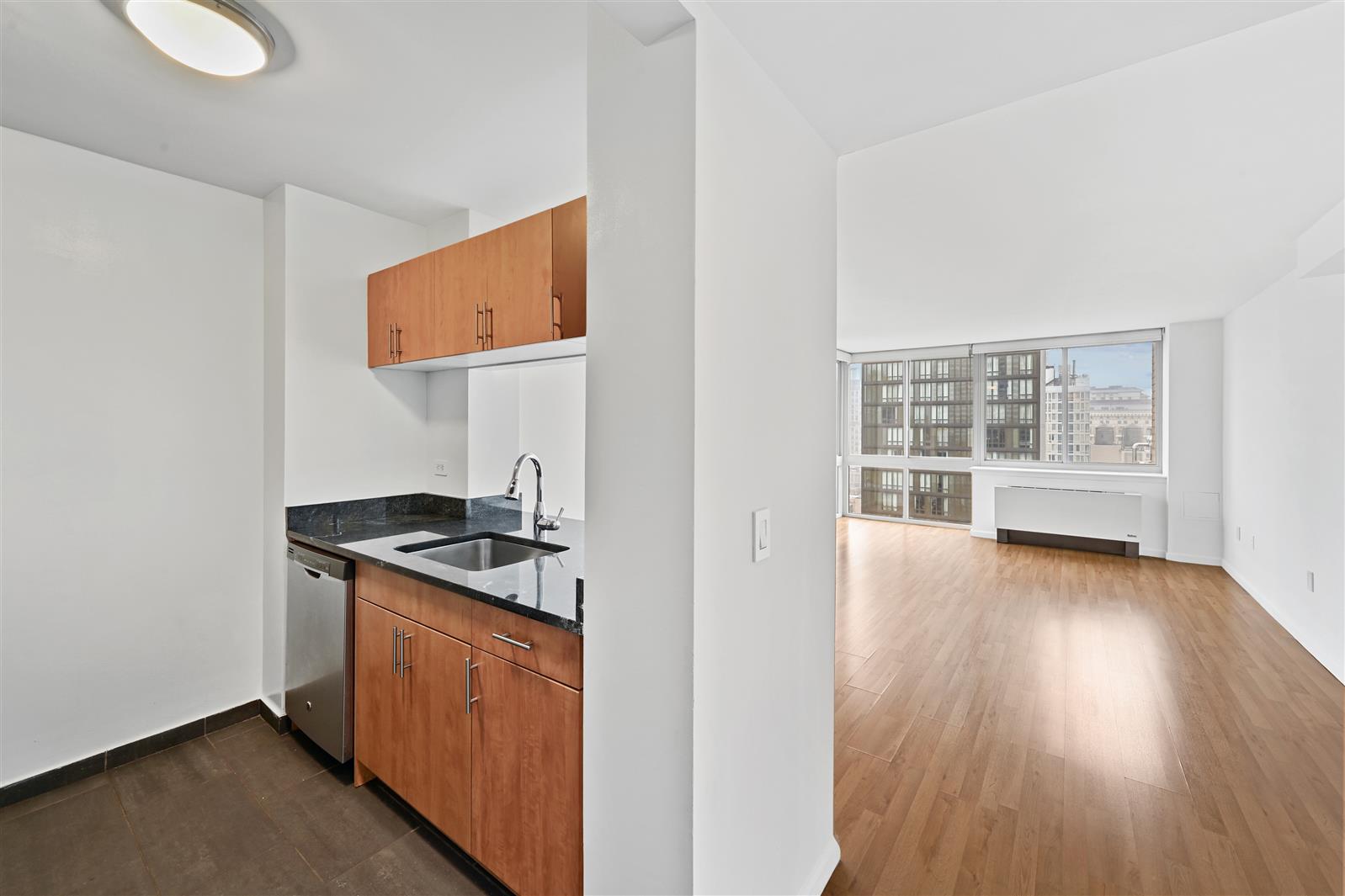 a kitchen with stainless steel appliances granite countertop a stove and a wooden floors