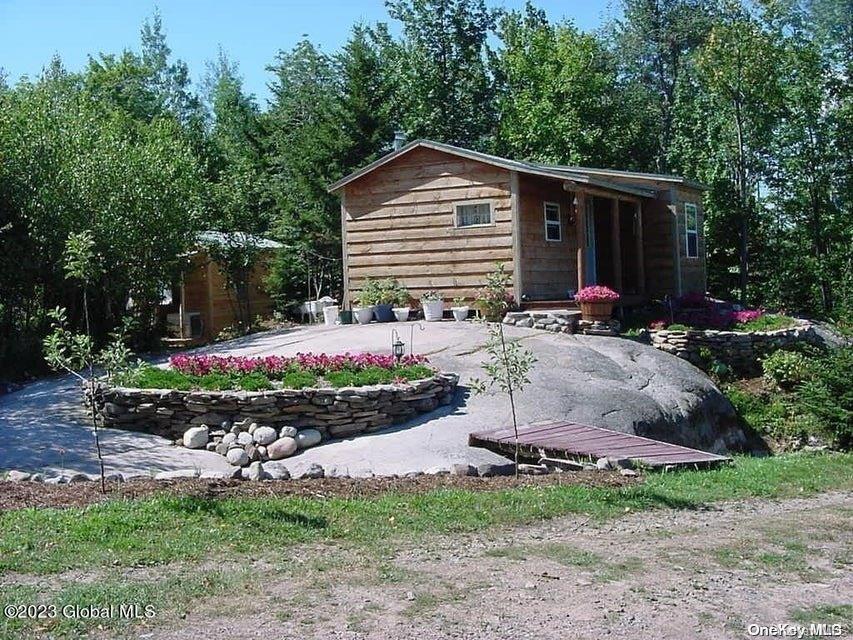 a front view of a house with yard and trees