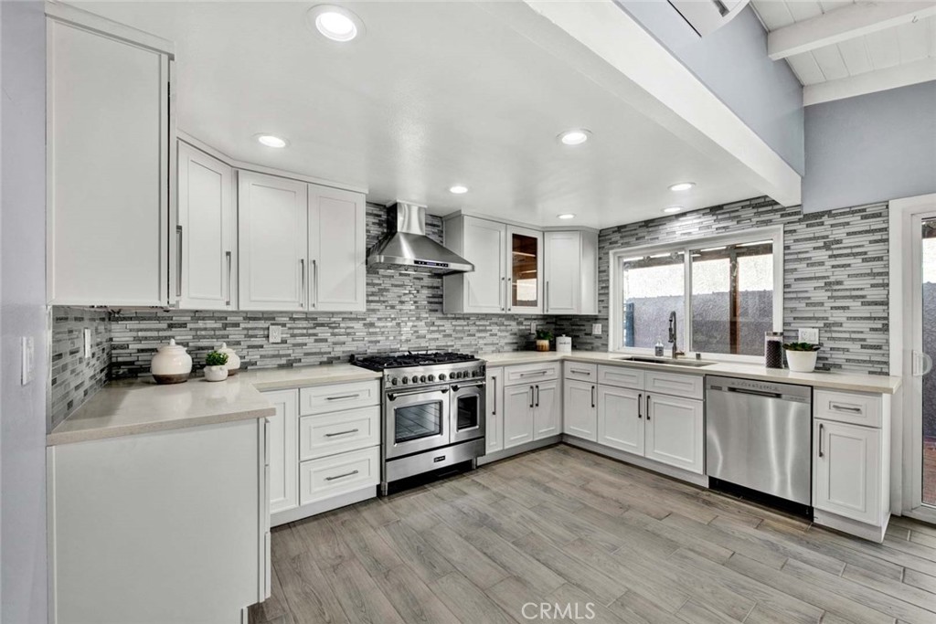 a kitchen with granite countertop white cabinets and white appliances