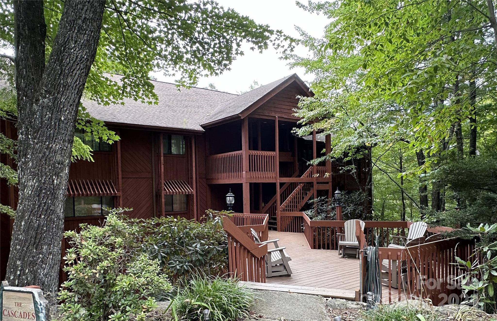 a view of house with outdoor seating and green space