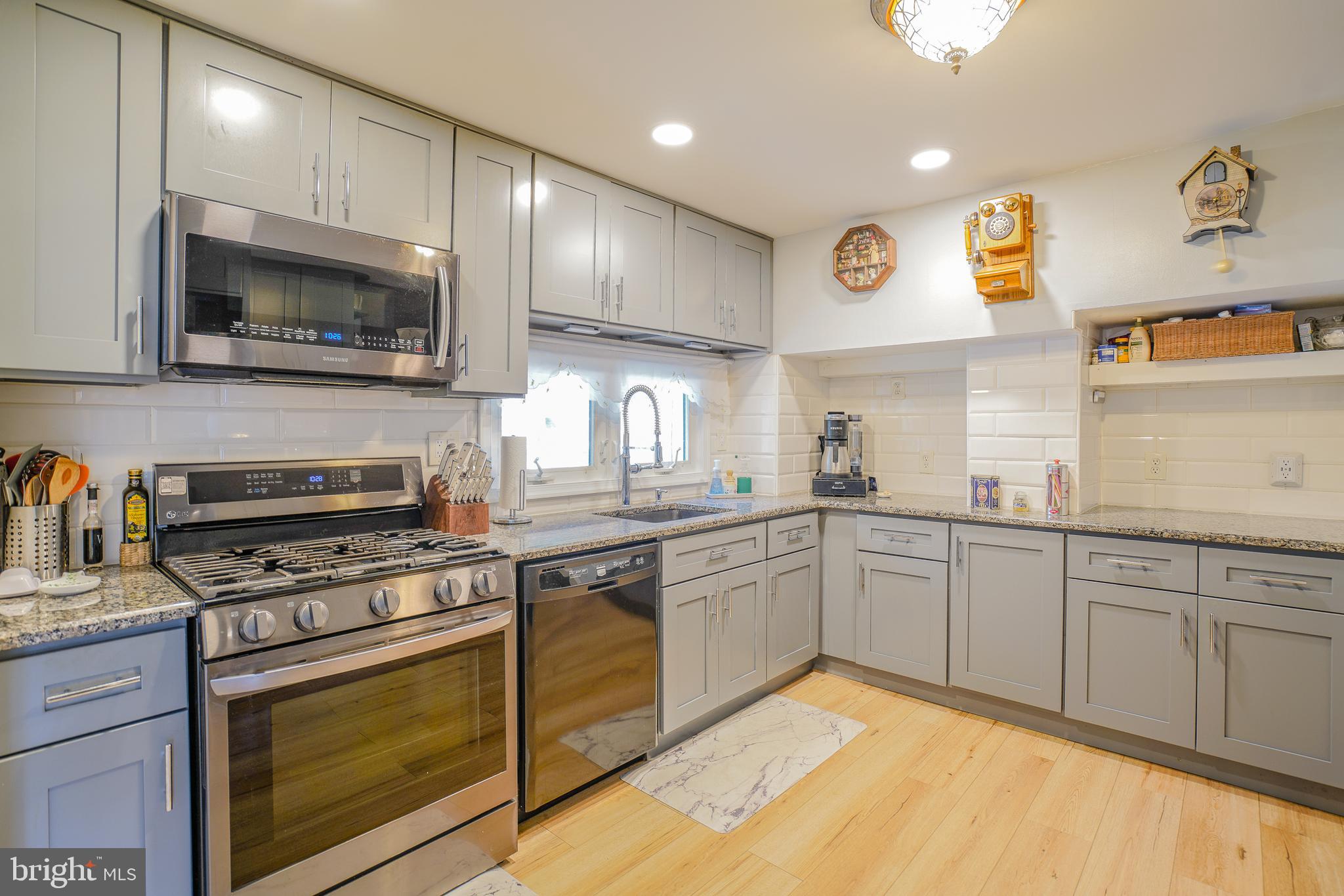 a kitchen with stainless steel appliances granite countertop a stove and a sink